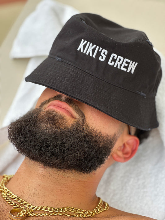 Male model wearing Kiki's crew black vintage bucket hat. this is a unisex product