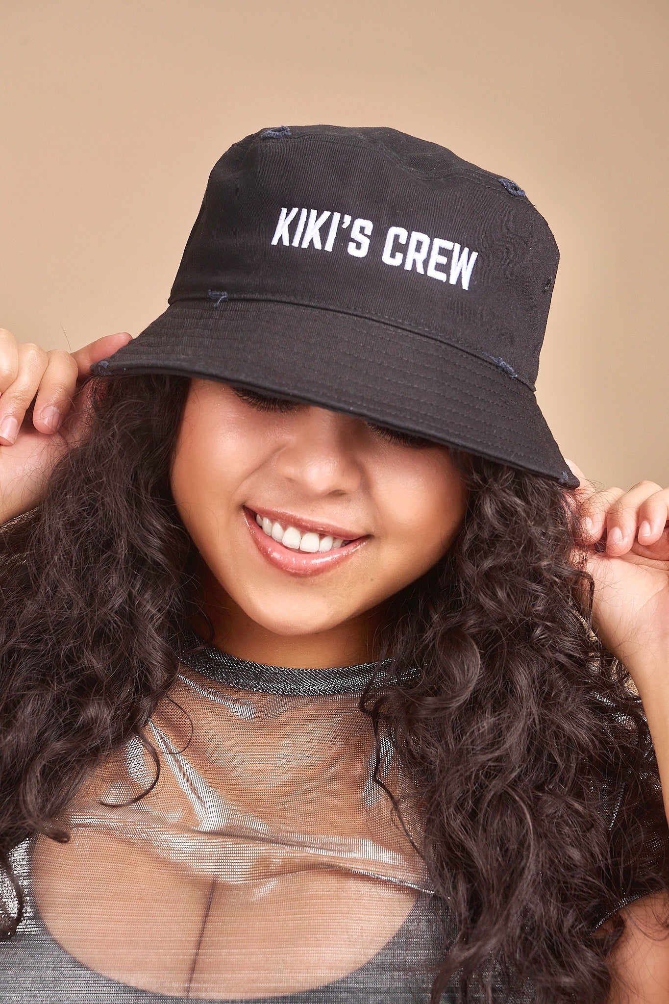 Female model wearing Kiki's crew black vintage bucket hat. this is a unisex product and accessory