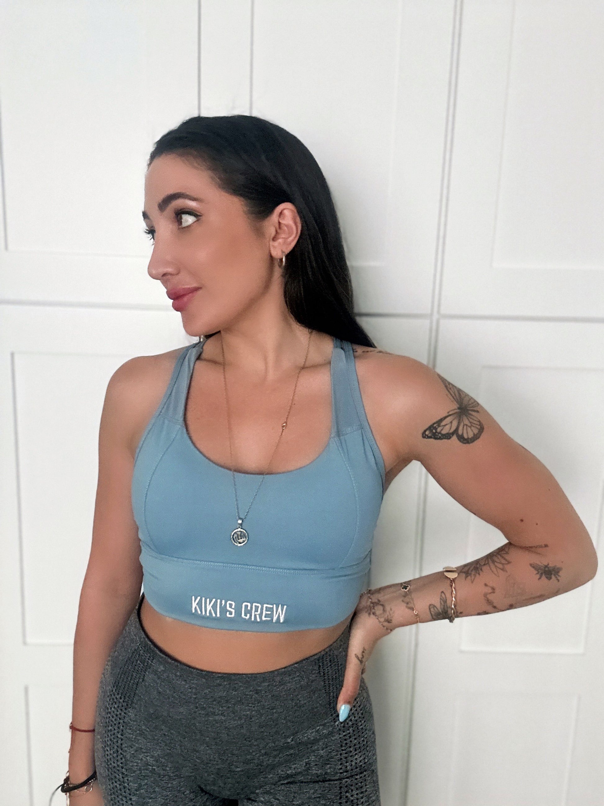 Model 1 wearing size small of kiki's crew baby blue sports bra