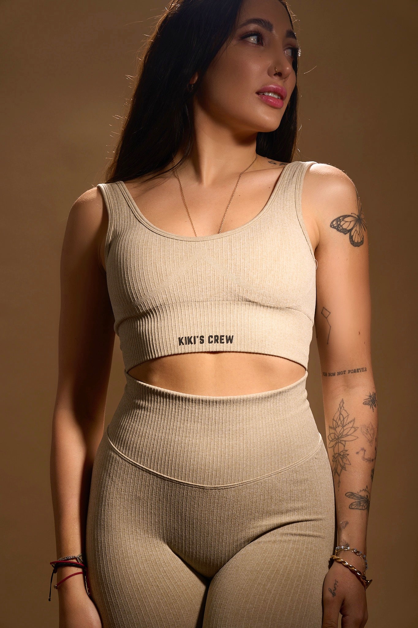 Model 1 wearing Kiki's Crew matching sports top and leggings, color beige, size small