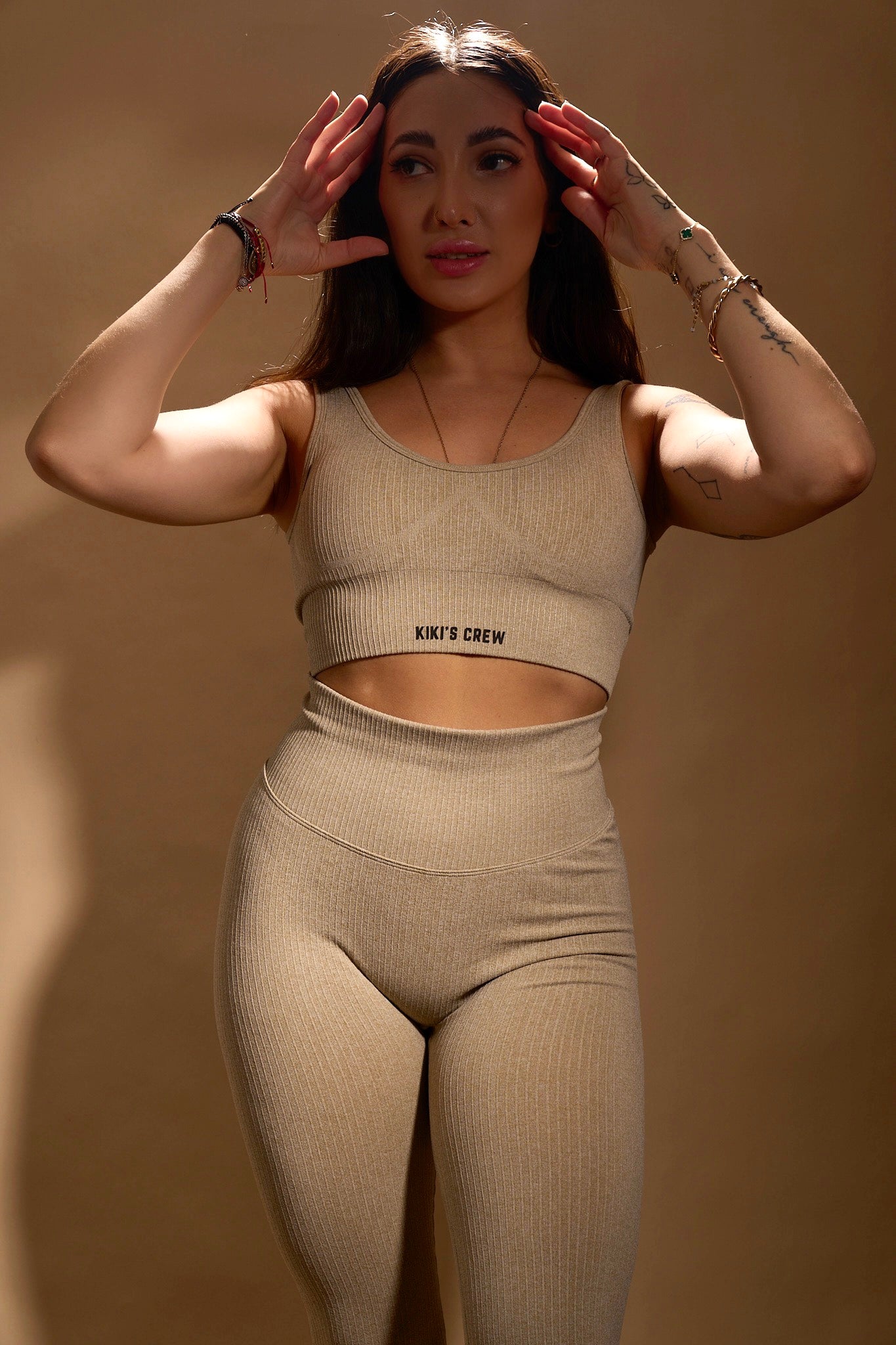 Model 1 wearing Kiki's Crew matching sports top and leggings, color beige, size small