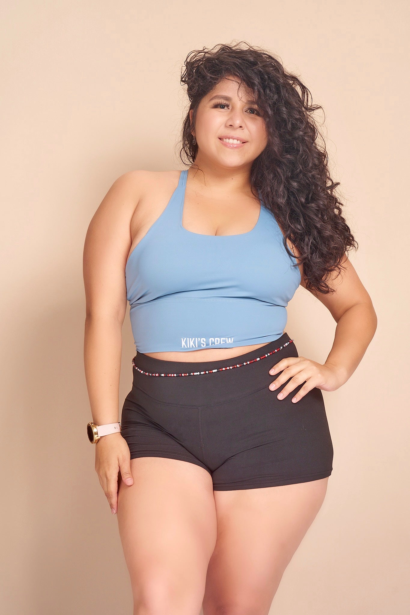 Model 2 wearing Kiki's crew baby blue sports tank top size large with kiki's crew basic spandex shorts size large