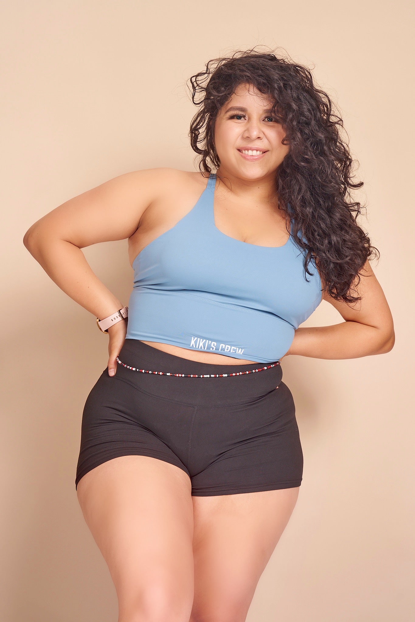 Model 2 wearing Kiki's crew baby blue sports tank top size large with kiki's crew basic spandex shorts size large