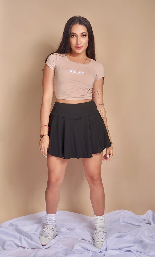 Model 1 wearing Kiki's crew size small t-shirt along with kiki's crew size small tennis skort