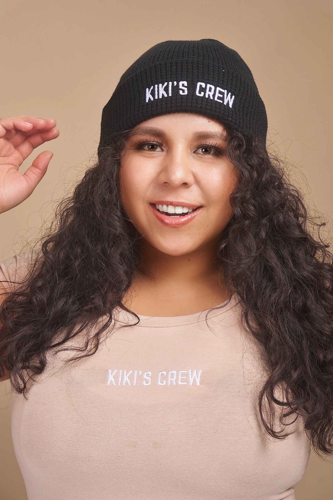 Model 2 wearing a black kiki's crew beanie. beanies are one size and unisex. she is also wearing a size large kiki's crew t-shirt 