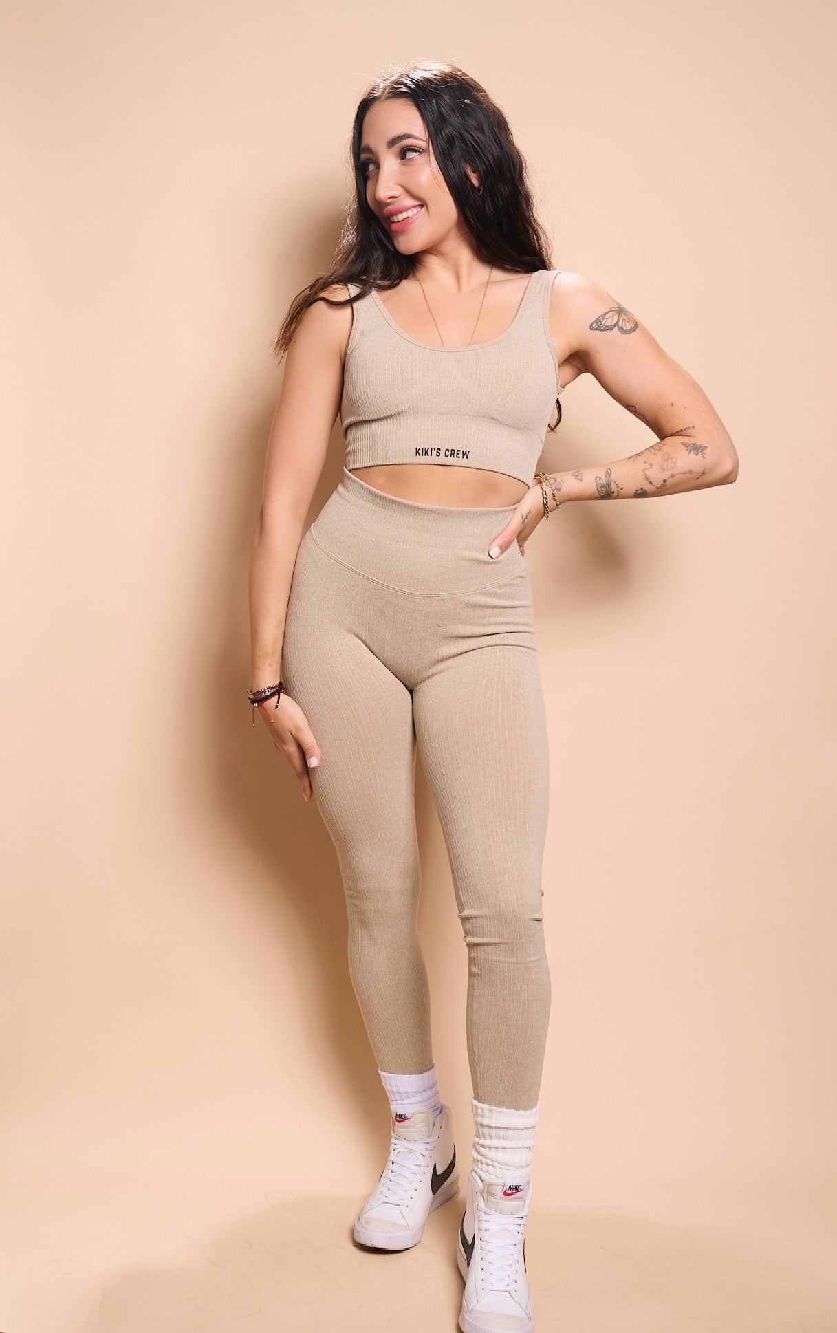 Model 1 wearing size small of the kiki's crew matching sports top and leggings, color beige 